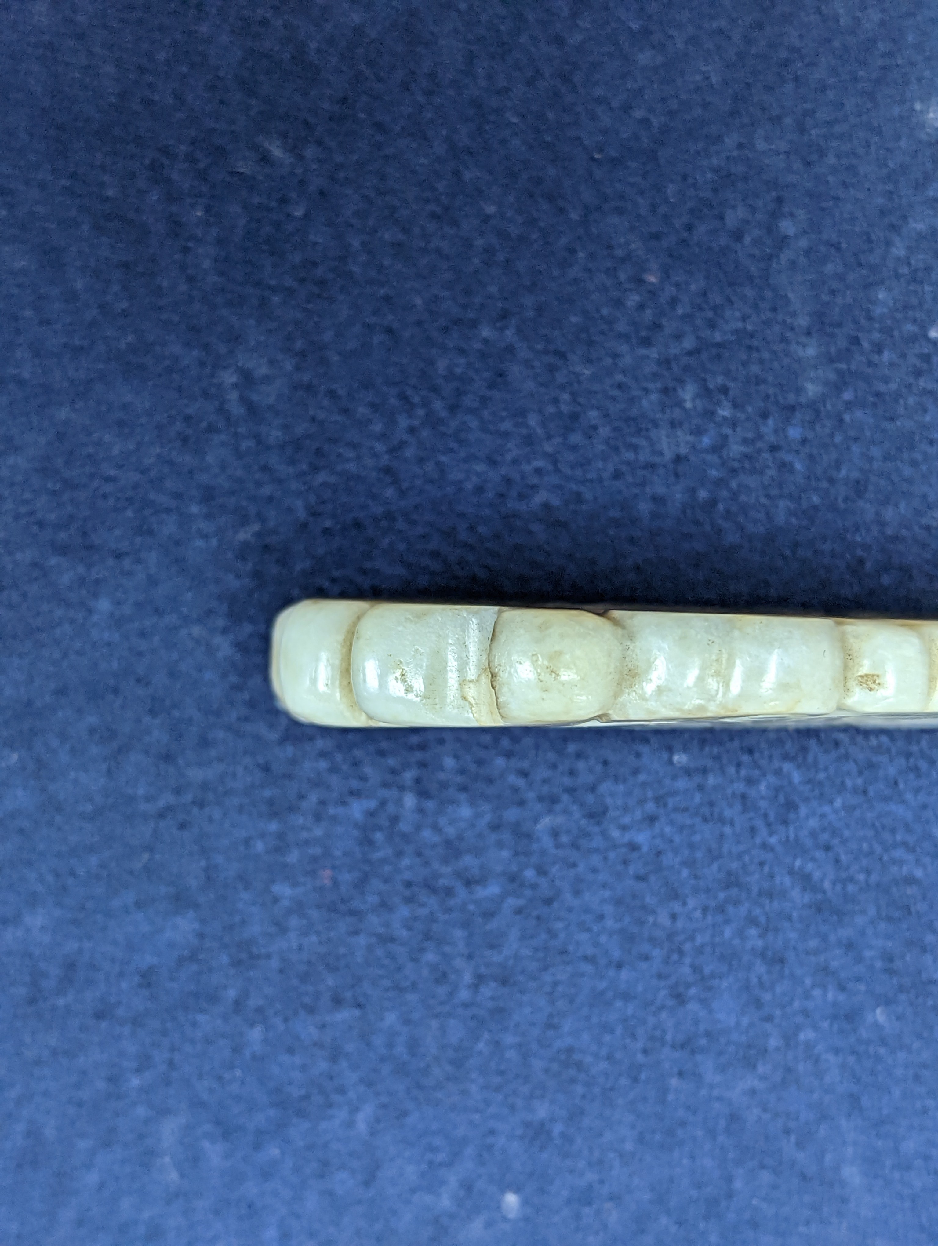 A Chinese white and black jade ‘dragon-fish’ plaque, 19th/20th century, 6cm